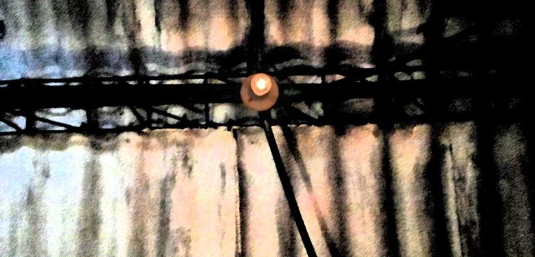 Image description: A single light bulb on the ceiling