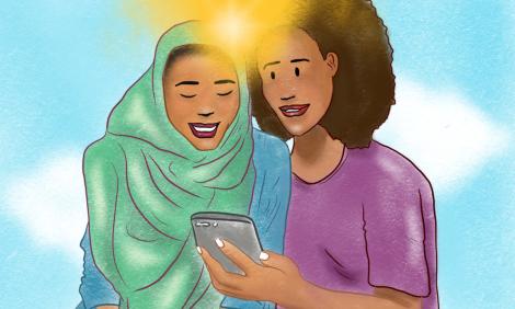 Two african women looking a mobile phone together