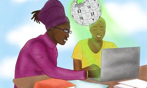 Dos mujeres negras trabajando juntas con una computadora