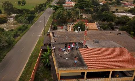 people installing a community antenna in a roof