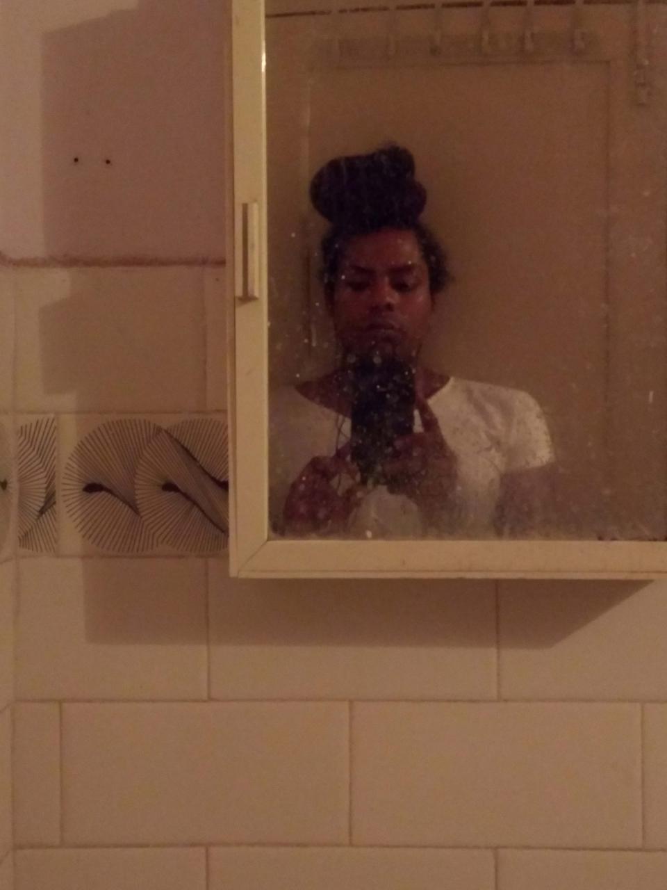 Image description: Part of a reflection of a person in the mirror